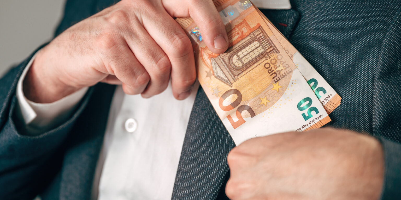 mp69564366-businessman-secretly-putting-50-euro-banknotes-into-suit